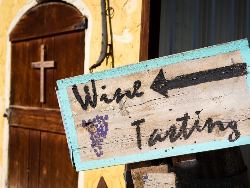 A sign that says "Wine tasting" outside a winery in New Mexico